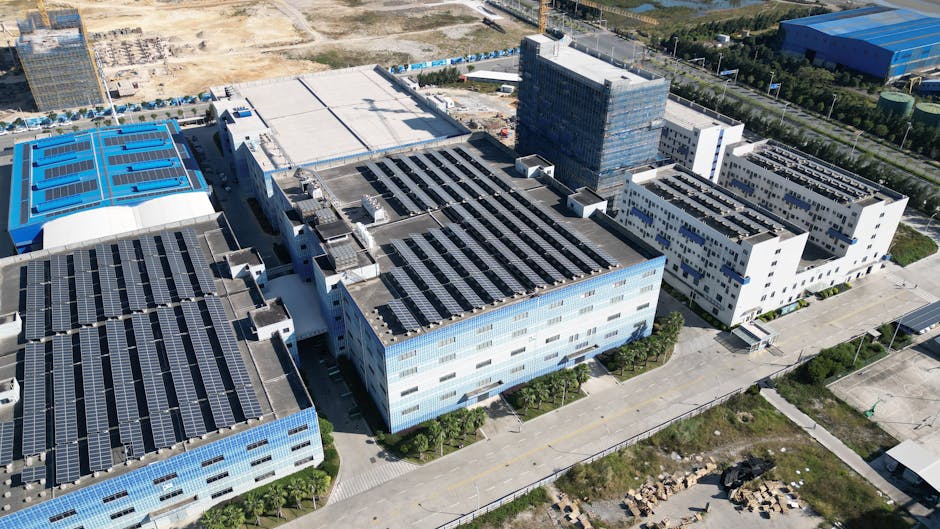 Industrial buildings with solar panels, aerial view showcasing renewable energy.