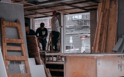 pexels-photo-6454230-6454230 Workers engaged in carpentry inside a building under construction, showcasing teamwork and skill.